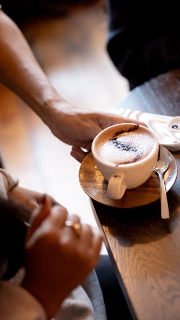 A cappuccino on a timber table by day